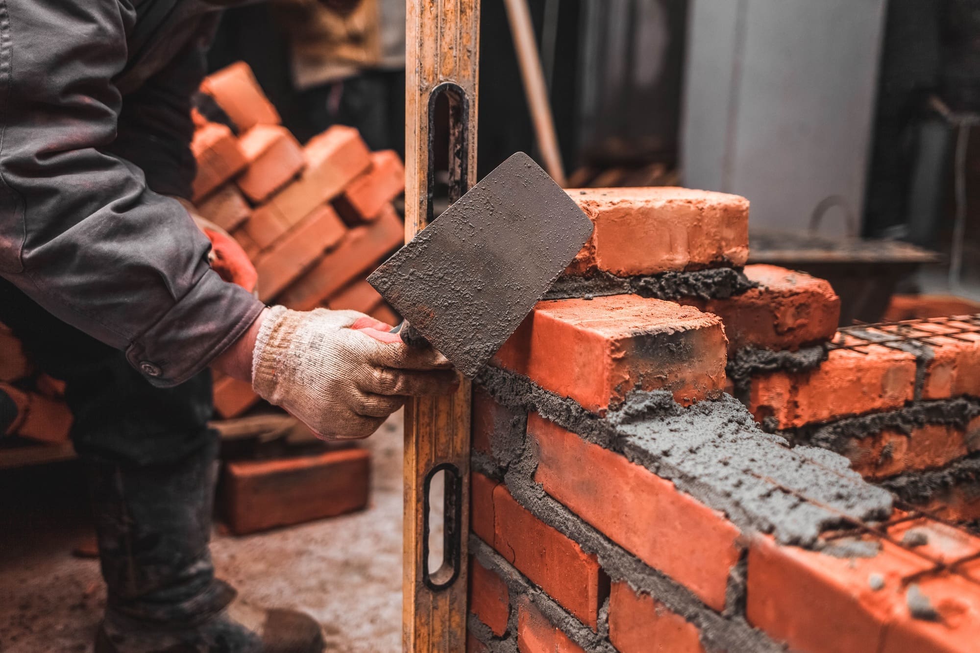 Bricklayer puts bricks to make a wall Bricklayer puts bricks to make a wall