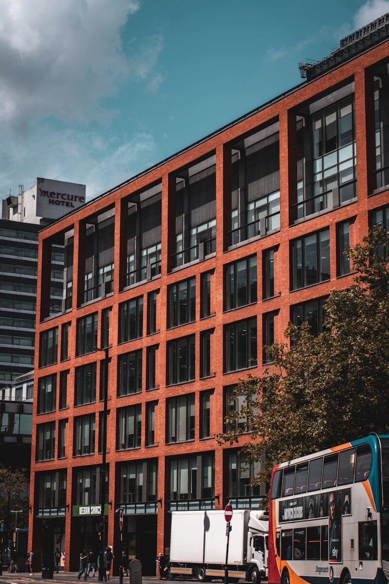 Photo by Sam Kimber a double decker bus parked in front of a building